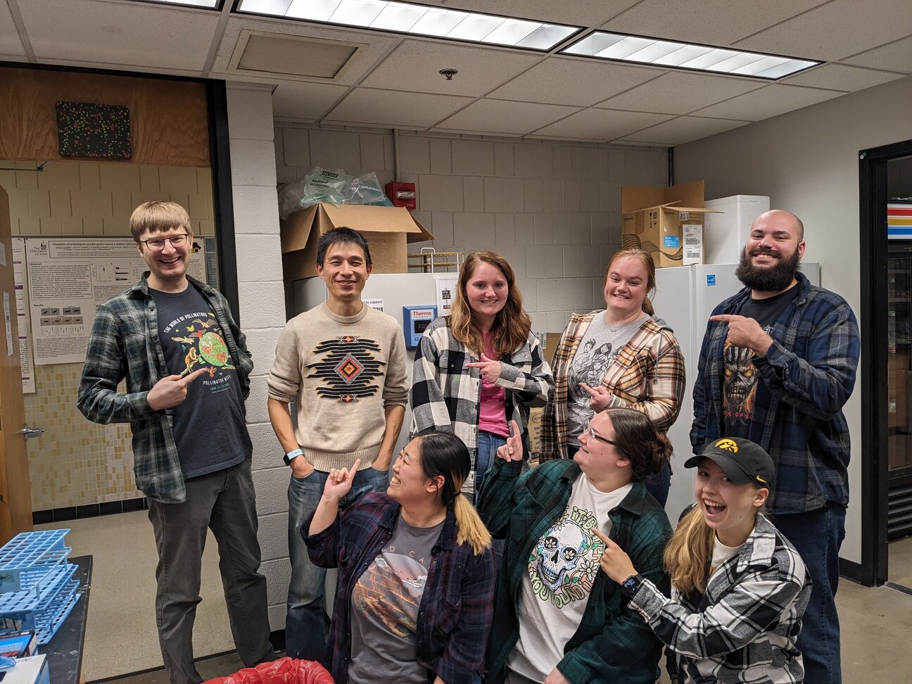 Lab members wearing flannel shirts while imitating Bin