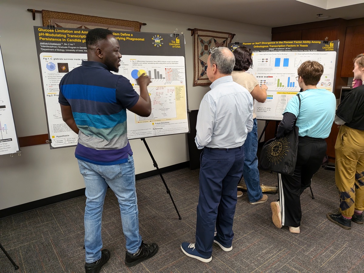 Visitors discussing research at the lab's posters during the Biology retreat